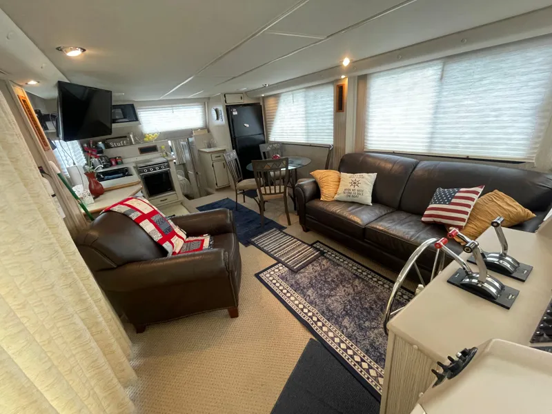 Slide: The Image of Interior of a 2003 Gibson 50 Classic houseboat with cozy seating and modern amenities. - 23