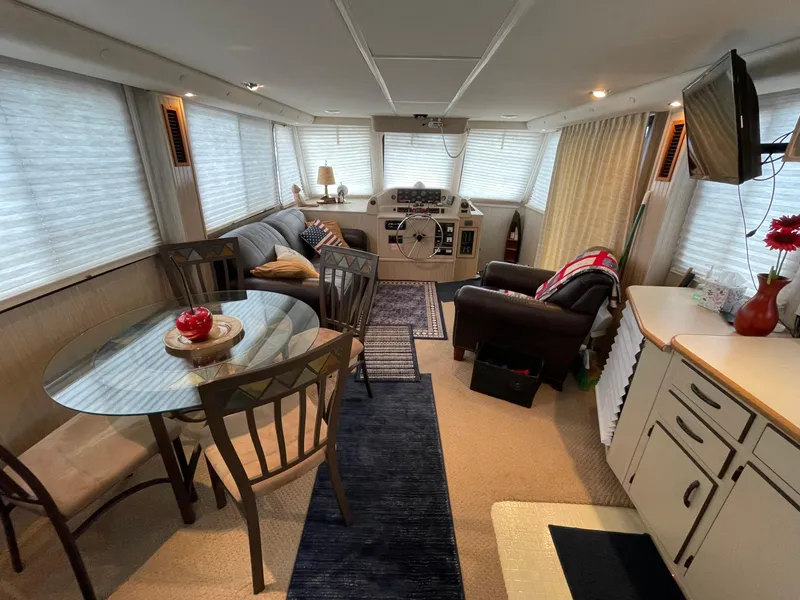 Slide: The Image of Spacious interior of a 2003 Gibson 50 Classic boat with cozy seating and dining area. - 24