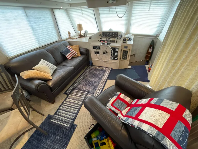 Slide: The Image of Cozy interior of a 2003 Gibson 50 Classic boat with leather seating and nautical decor. - 25