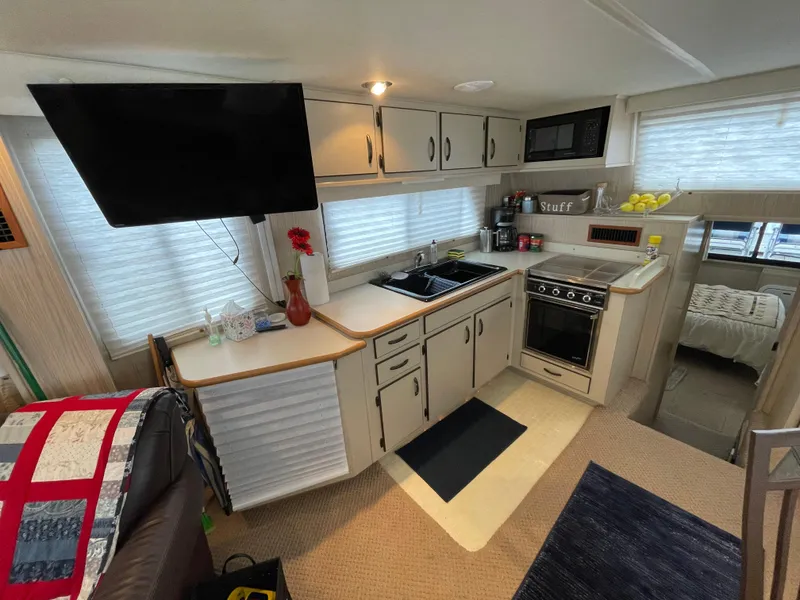 Slide: The Image of Interior of a 2003 Gibson 50 Classic houseboat kitchen with modern amenities. - 26