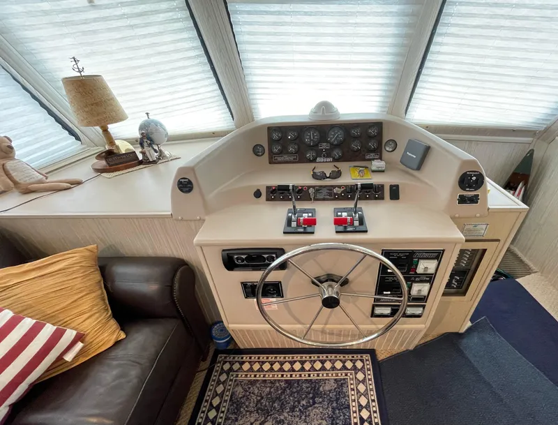 Slide: The Image of 2003 Gibson 50 Classic boat helm with steering wheel and control panel. - 30