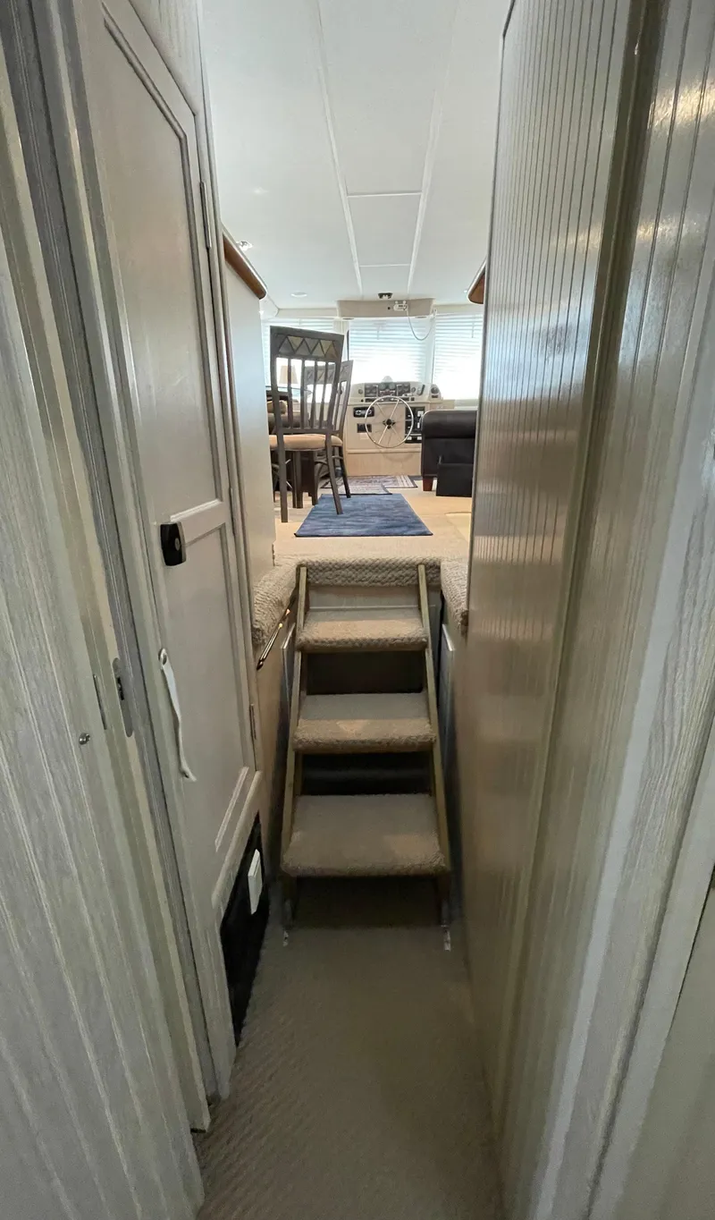 Slide: The Image of Narrow hallway with stairs leading to a bright room in a 2003 Gibson 50 Classic boat. - 31