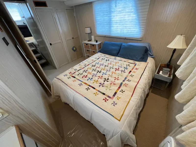 Slide: The Image of Cozy bedroom in a 2003 Gibson 50 Classic boat with quilted bedspread and soft lighting. - 33