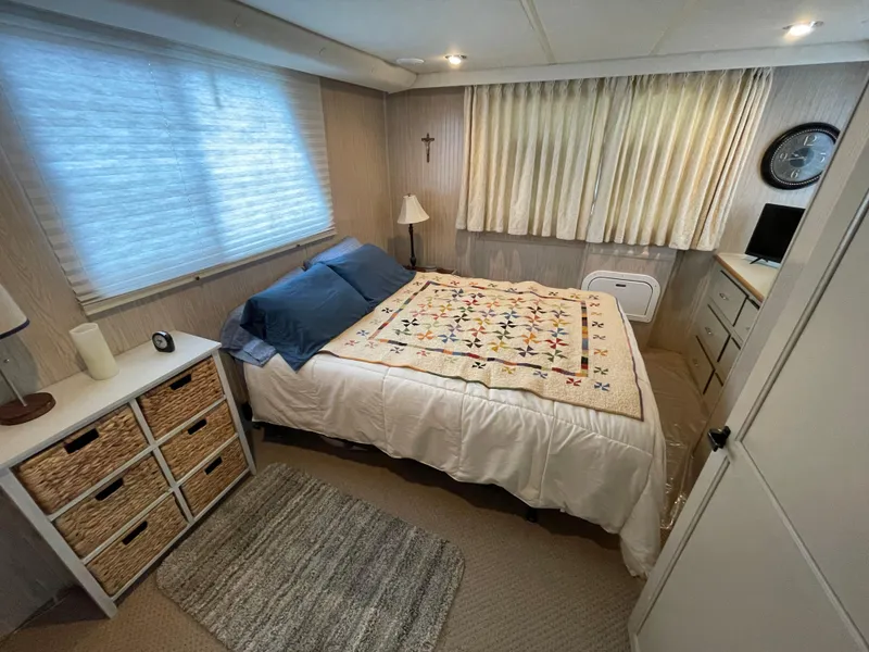 Slide: The Image of Cozy bedroom with quilted bedspread, wicker storage, and soft lighting in a Gibson 50 Classic, 2003. - 34