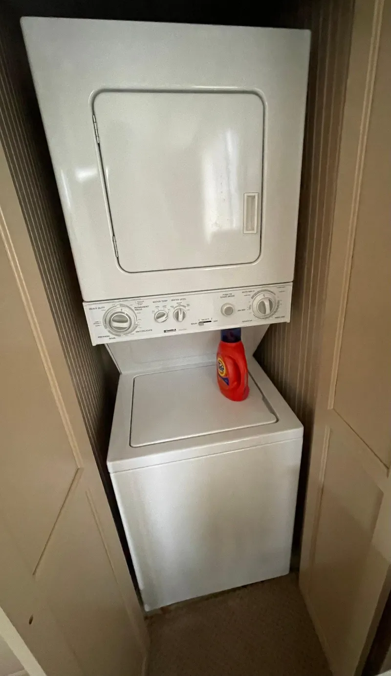 Slide: The Image of Stacked washer and dryer unit in a compact laundry space with detergent bottle. - 37
