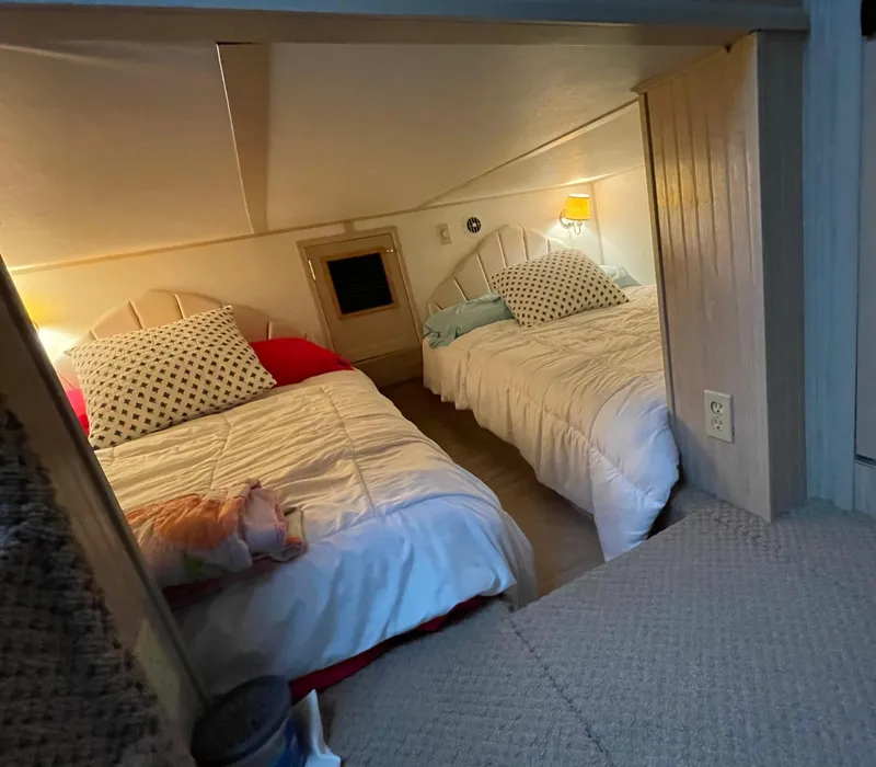 Slide: The Image of Cozy bedroom with two beds, soft lighting, and decorative pillows in a compact space. - 41