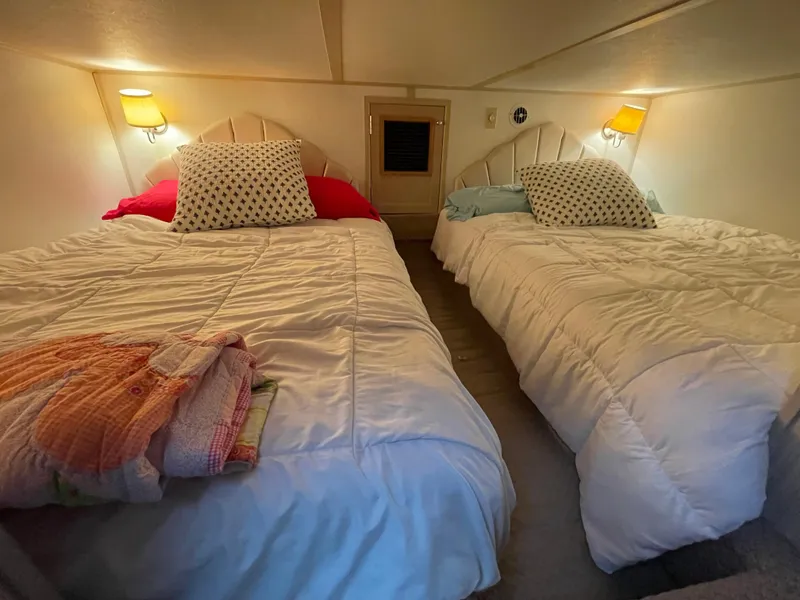Slide: The Image of Cozy bedroom with two beds, warm lighting, and colorful pillows in a Gibson 50 Classic, 2003. - 42