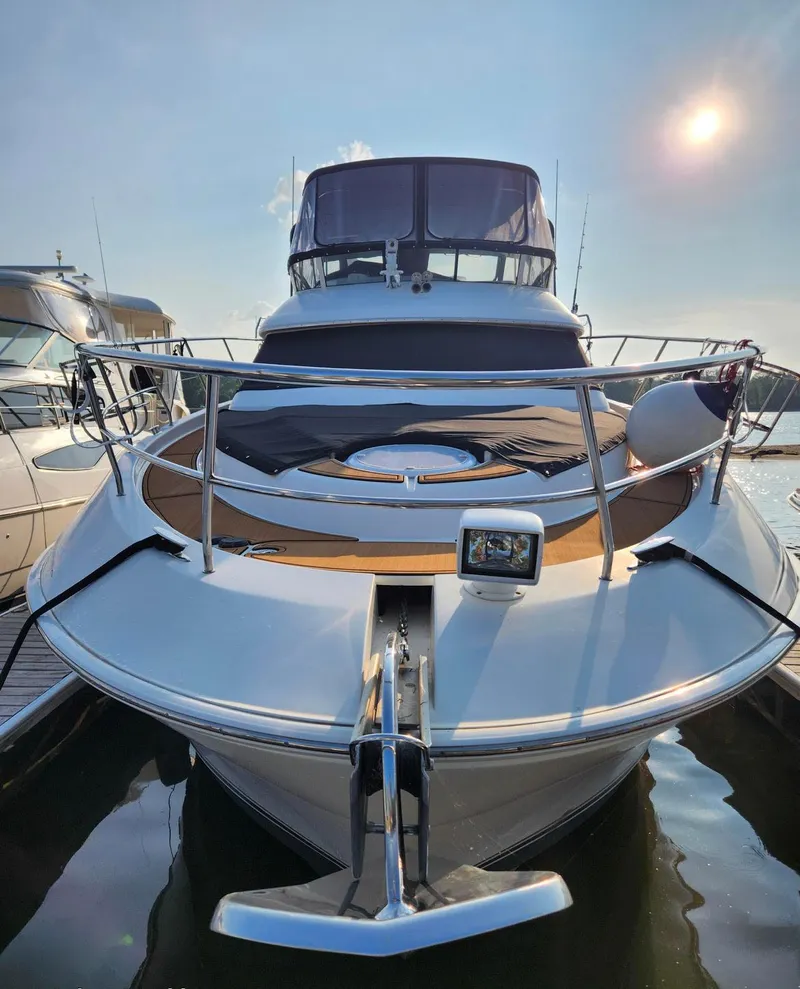 Slide: The Image of 2008 Silverton Sport Bridge yacht docked under a bright sun. - 2