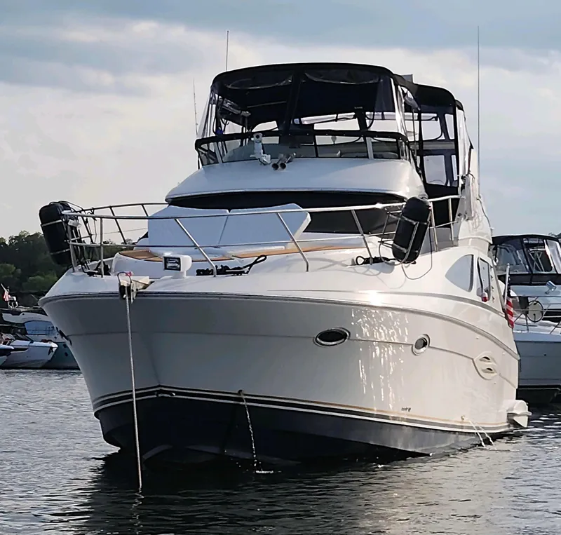 Slide: The Image of 2008 Silverton Sport Bridge yacht docked on calm water. - 3