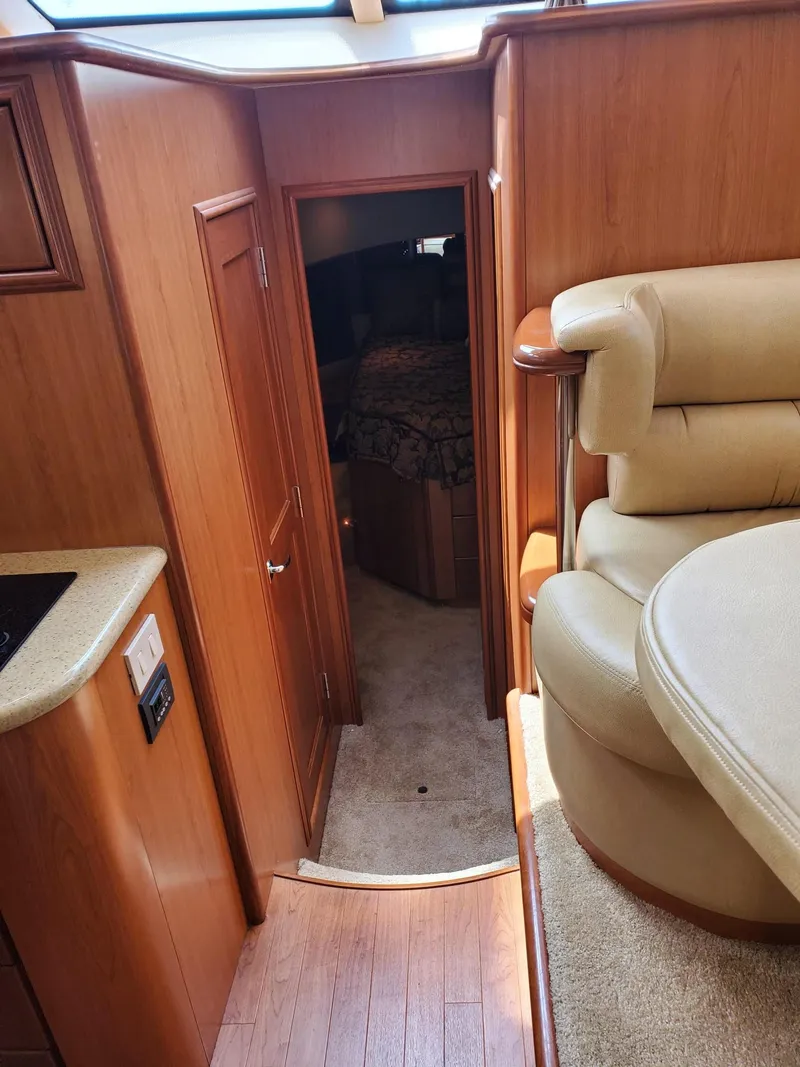 Slide: The Image of 2008 Silverton Sport Bridge interior with wood paneling and cozy seating area. - 34