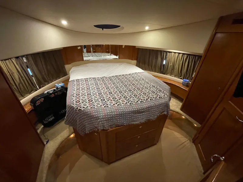 Slide: The Image of 2008 Silverton Sport Bridge interior cabin with bed and wooden furnishings. - 41