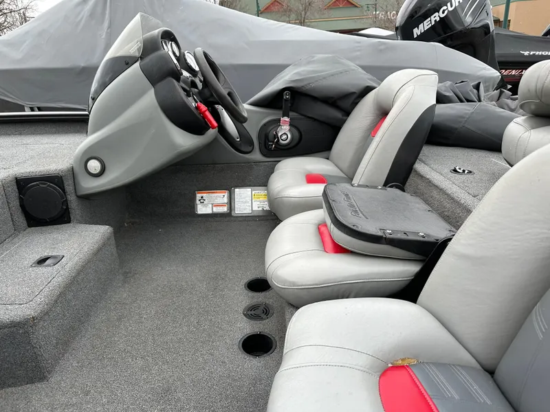 Slide: The Image of 2017 Tracker Pro Team 195 TXW boat interior with gray and red seating, steering console. - 4