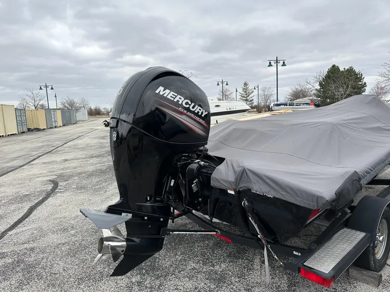 Slide: The Image of 2017 Tracker Pro Team 195 TXW boat with Mercury engine, covered and parked outdoors. - 5