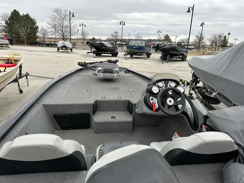 Slide: The Image of 2017 Tracker Pro Team 195 TXW boat interior with steering wheel and seating. - 6