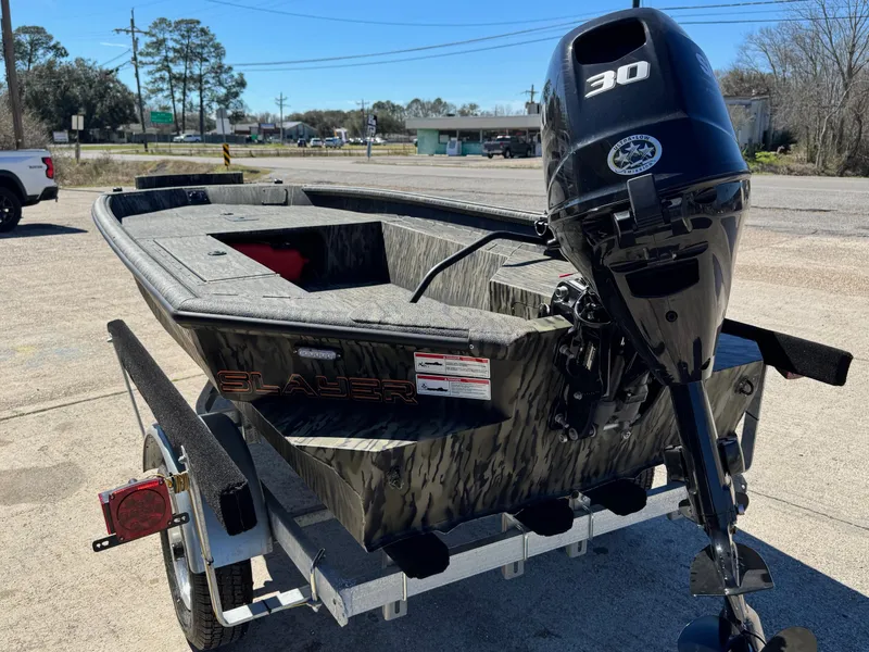 Slide: The Image of 2025 SeaArk 1648 Slayer Pro boat with 30 HP motor on trailer. - 10