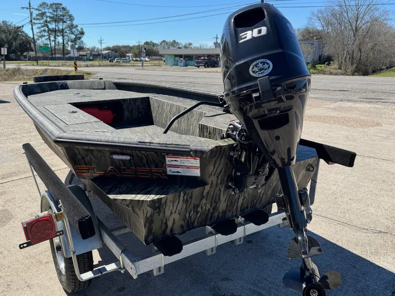 Slide: The Image of 2025 SeaArk 1648 Slayer Pro boat with 30 HP motor on trailer. - 11