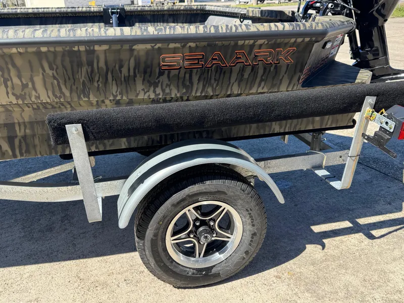 Slide: The Image of 2025 SeaArk 1648 Slayer Pro boat on trailer, featuring camouflage design and durable construction. - 12