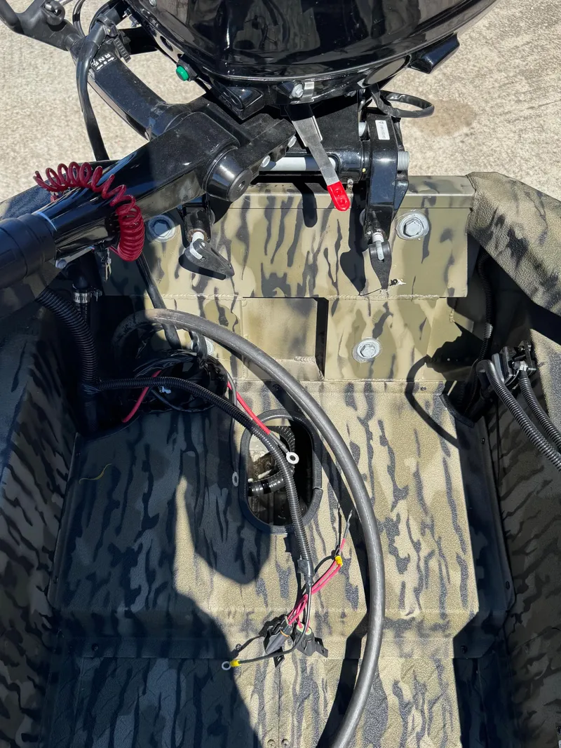 Slide: The Image of 2025 SeaArk 1648 Slayer Pro boat interior with camouflage design and wiring details. - 13