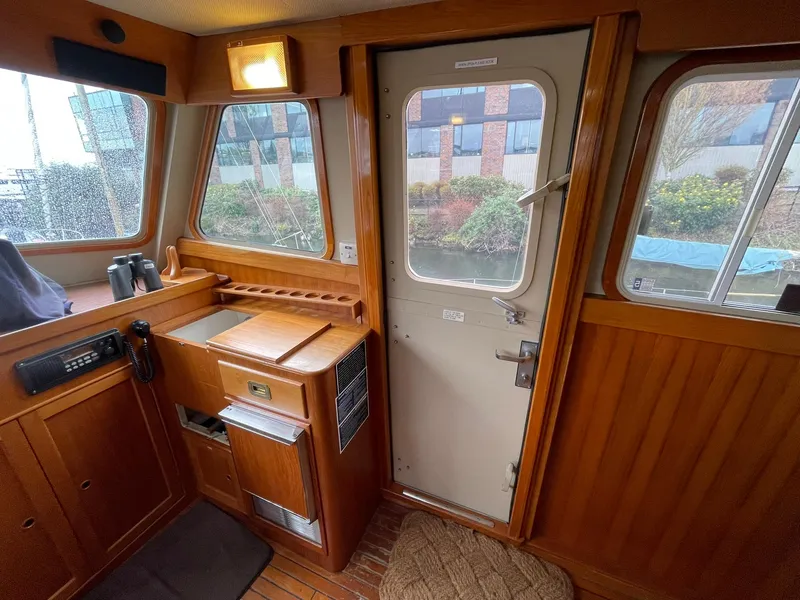 Slide: The Image of Interior of 1972 Grand Banks Alaskan 55 yacht with wooden paneling and windows. - 10