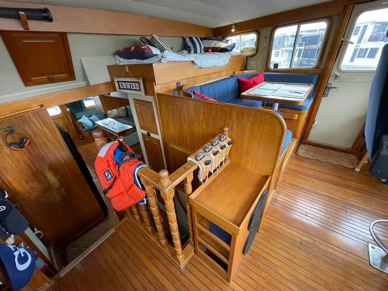 Slide: The Image of Interior of 1972 Grand Banks Alaskan 55 yacht with wooden furnishings and cozy seating area. - 11