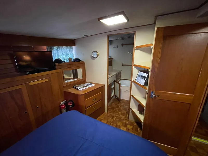 Slide: The Image of Interior of 1972 Grand Banks Alaskan 55 yacht with wooden furnishings and cozy bedroom. - 21