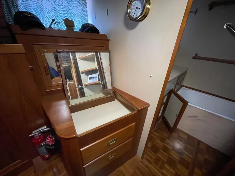 Slide: The Image of 1972 Grand Banks Alaskan 55 interior with wooden cabinetry and mirror. - 24