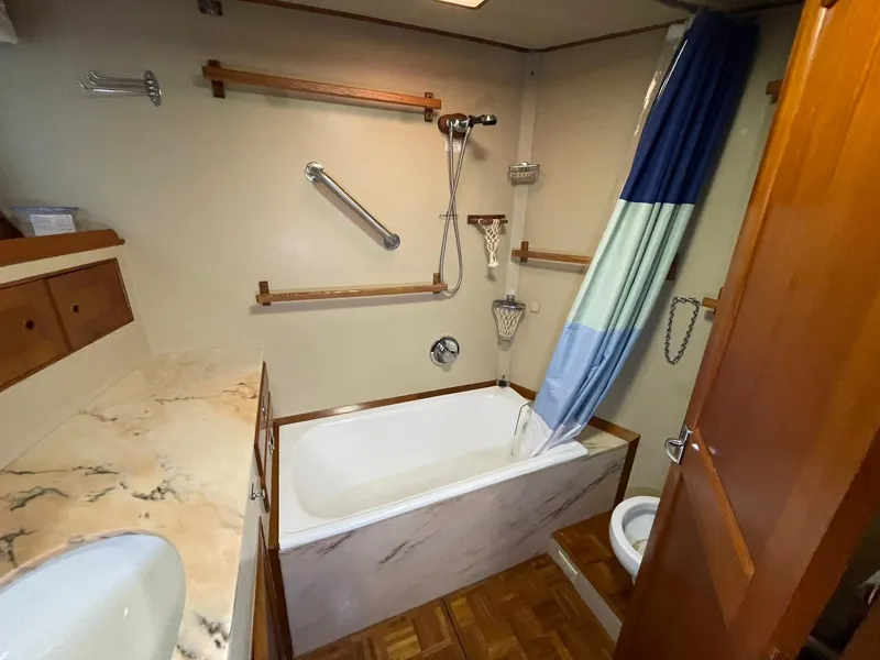 Slide: The Image of Bathroom interior of 1972 Grand Banks Alaskan 55 yacht with bathtub and shower. - 26