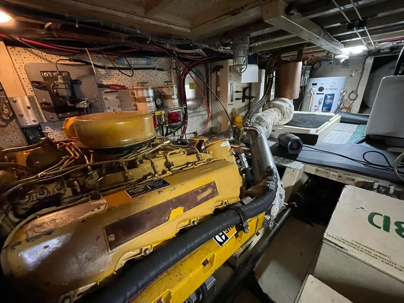 Slide: The Image of Engine room of a 1972 Grand Banks Alaskan 55 yacht, featuring a yellow engine. - 35