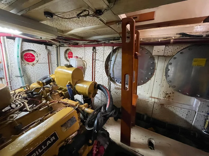 Slide: The Image of Engine room of 1972 Grand Banks Alaskan 55 with Caterpillar engine and mechanical components. - 39
