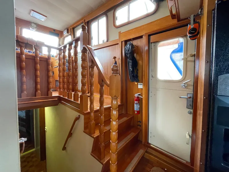 Slide: The Image of Interior of 1972 Grand Banks Alaskan 55 yacht with wooden stairs and door. - 40