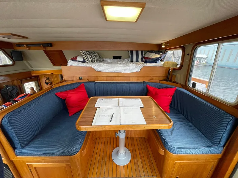 Slide: The Image of Interior of 1972 Grand Banks Alaskan 55 yacht with cozy dining area and blue seating. - 8
