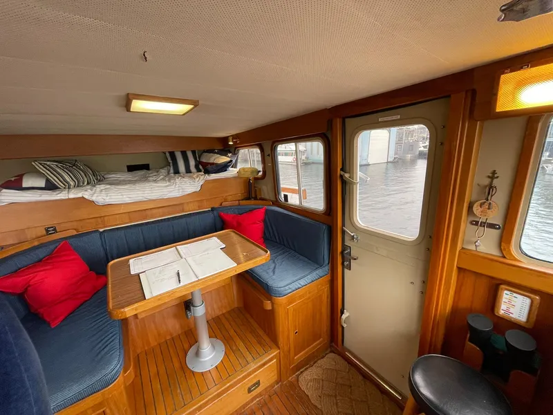 Slide: The Image of Interior of 1972 Grand Banks Alaskan 55 with cozy seating and nautical decor. - 9