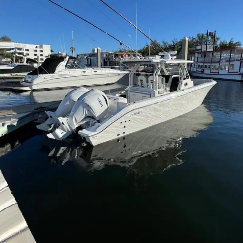 The Image of 2025 Pursuit S 328 Sport boat docked in marina, clear blue sky. - 0