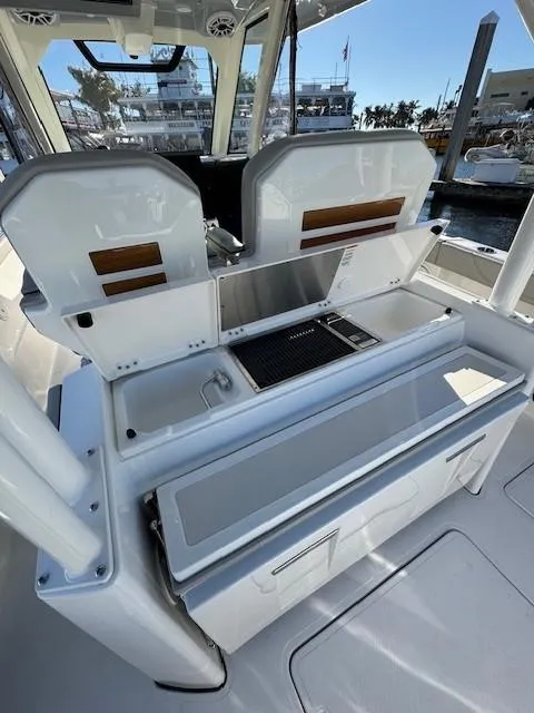 Slide: The Image of 2025 Pursuit S 328 Sport boat interior with open storage compartments and modern design. - 10