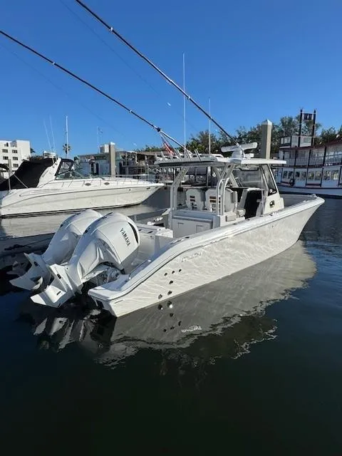 Slide: The Image of 2025 Pursuit S 328 Sport boat docked in marina under clear blue sky. - 11