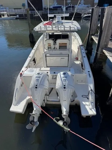 Slide: The Image of 2025 Pursuit S 328 Sport boat docked with twin engines, rear view. - 12