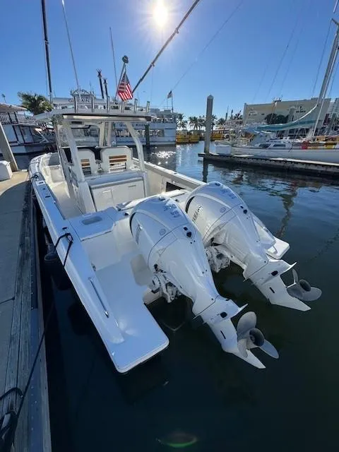 Slide: The Image of 2025 Pursuit S 328 Sport boat docked with dual outboard engines. - 4
