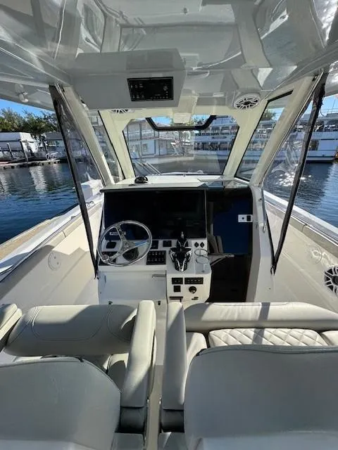 Slide: The Image of 2025 Pursuit S 328 Sport boat interior with modern helm and seating. - 5