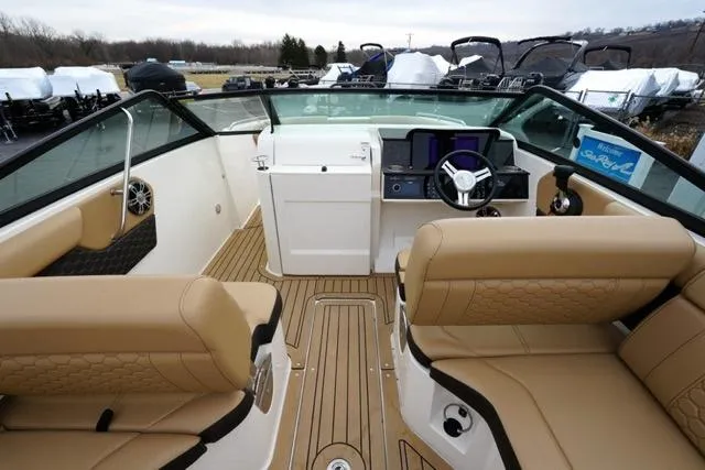 Slide: The Image of 2021 Sea Ray SDX 250 boat interior with tan seating and modern dashboard. - 12
