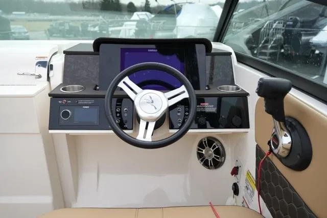 Slide: The Image of 2021 Sea Ray SDX 250 boat dashboard with steering wheel and control panel. - 14
