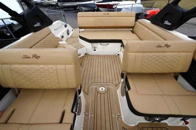 Slide: The Image of 2021 Sea Ray SDX 250 boat interior with tan leather seating and wood flooring. - 15