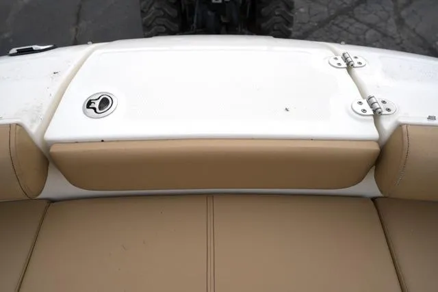 Slide: The Image of 2021 Sea Ray SDX 250 boat seating area with beige upholstery and white deck. - 18