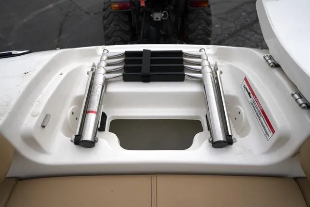 Slide: The Image of 2021 Sea Ray SDX 250 boat ladder compartment with stainless steel retractable ladder. - 19