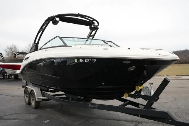 Slide: The Image of 2021 Sea Ray SDX 250 boat on trailer, black hull, parked outdoors. - 4