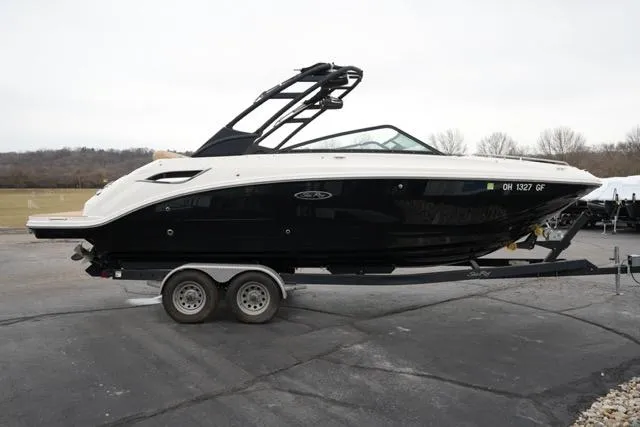 Slide: The Image of 2021 Sea Ray SDX 250 boat on trailer, black and white design, parked outdoors. - 5