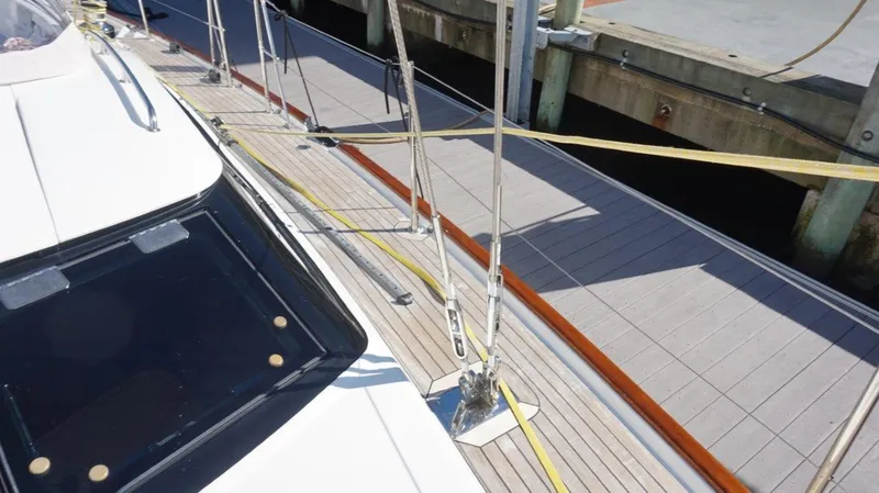 Slide: The Image of Deck of 2008 Oyster 46 yacht docked at marina, showing rigging and sleek design. - 13