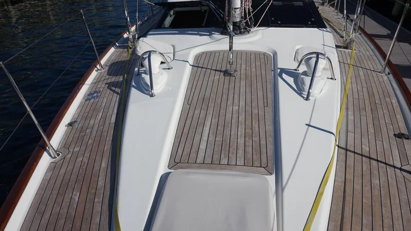 Slide: The Image of Deck view of 2008 Oyster 46 sailboat with teak wood finish and sleek design. - 16