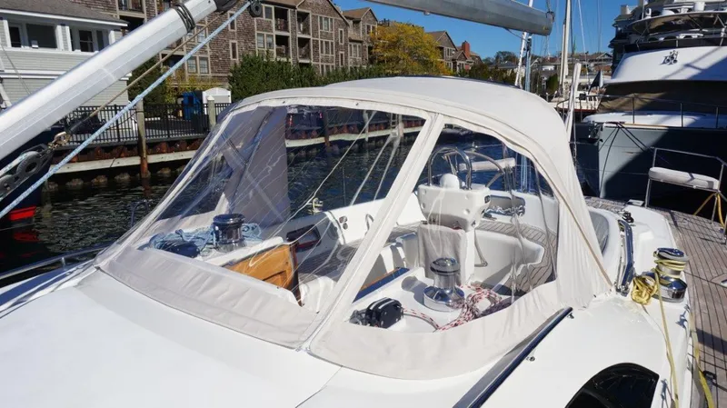 Slide: The Image of 2008 Oyster 46 yacht with covered cockpit, docked in a marina. - 17