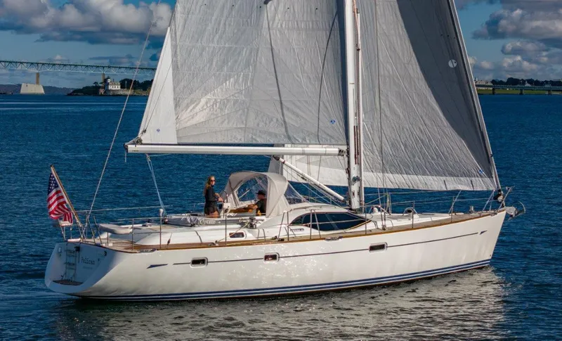 Slide: The Image of 2008 Oyster 46 sailboat cruising on calm waters under a clear sky. - 2