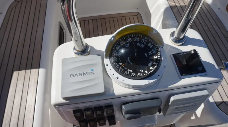 Slide: The Image of Compass and Garmin device on 2008 Oyster 46 yacht's navigation panel. - 20